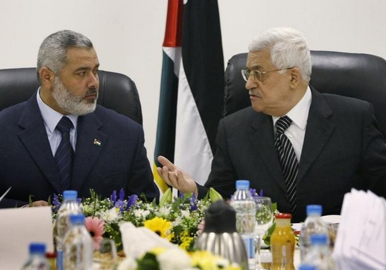Palestinian Authority President Mahmoud Abbas (R) talks with Hamas leader Ismail Haniyeh.. (photo credit:REUTERS)