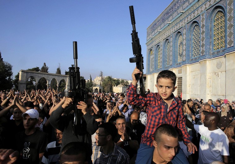 Palestinian children hold toy guns during a protest on the compound known to Muslims as al-Haram al-Sharif and to Jews as Temple Mount in Jerusalem's Old City,