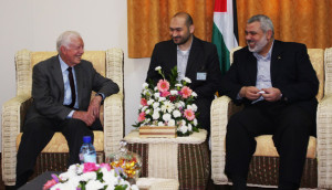 The head of Hamas goverment in the Gaza Strip, Ismail Haniyeh (R), sits with former U.S. President Jimmy Carter in Gaza City, the Gaza Strip. Carter is in the Gaza strip.