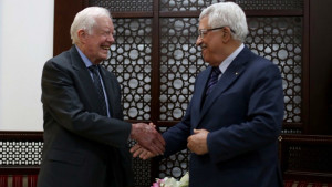 Palestinian Authority President Mahmud Abbas shakes hands with former US president Jimmy Carter