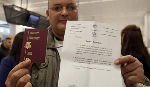 A would-be passenger posing with his passport and a letter denying him access to Israel as around 100 pro-Palestinian activists stage a protest at Brussels national airport April 15, 2012.