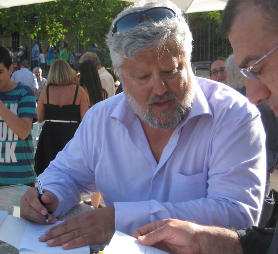 Gershon Baskin autographing his book.