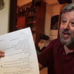 Gershon Baskin holds the draft agreement between Israel and Hamas for the release of Gilad Shalit at his home in Jerusalem, October 12, 2011