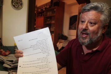 Gershon Baskin holds the draft agreement between Israel and Hamas for the release of Gilad Shalit at his home in Jerusalem, October 12, 2011